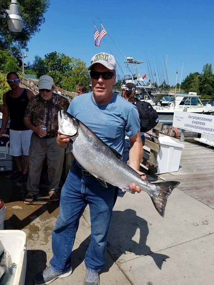 3 people fishing with big 42-inch fish in MI