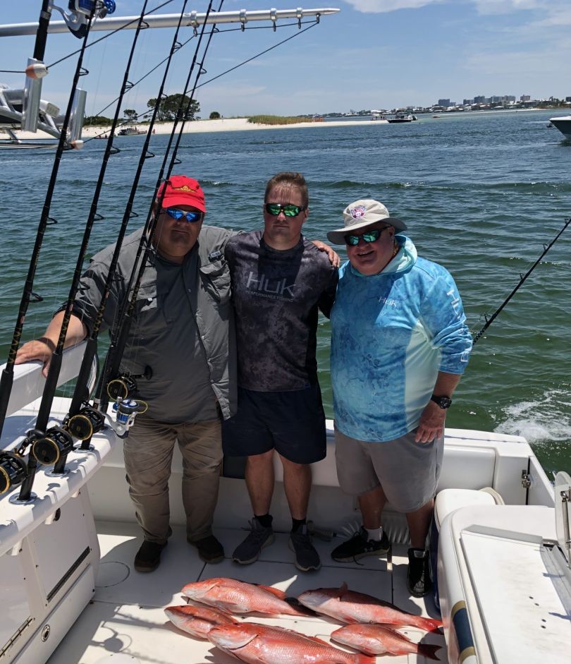 Three people fishing on the water in AL