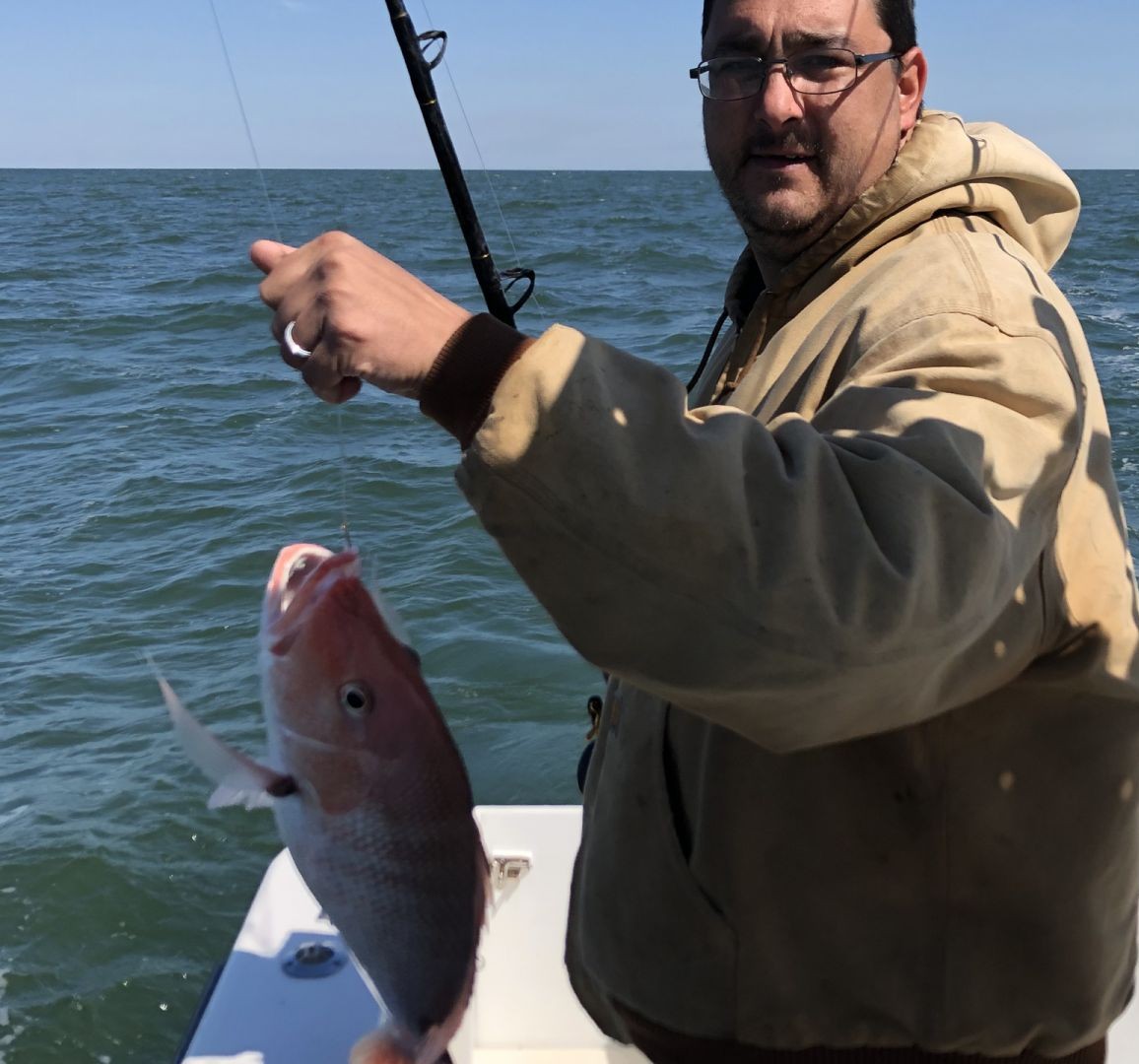 Three anglers fishing in the waters of Gulf Shores