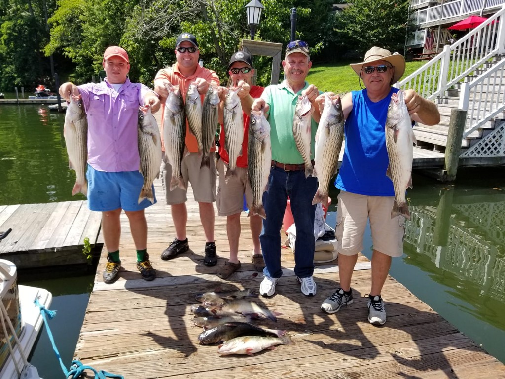 Group of five people fishing for 10 striped bass in Hardy