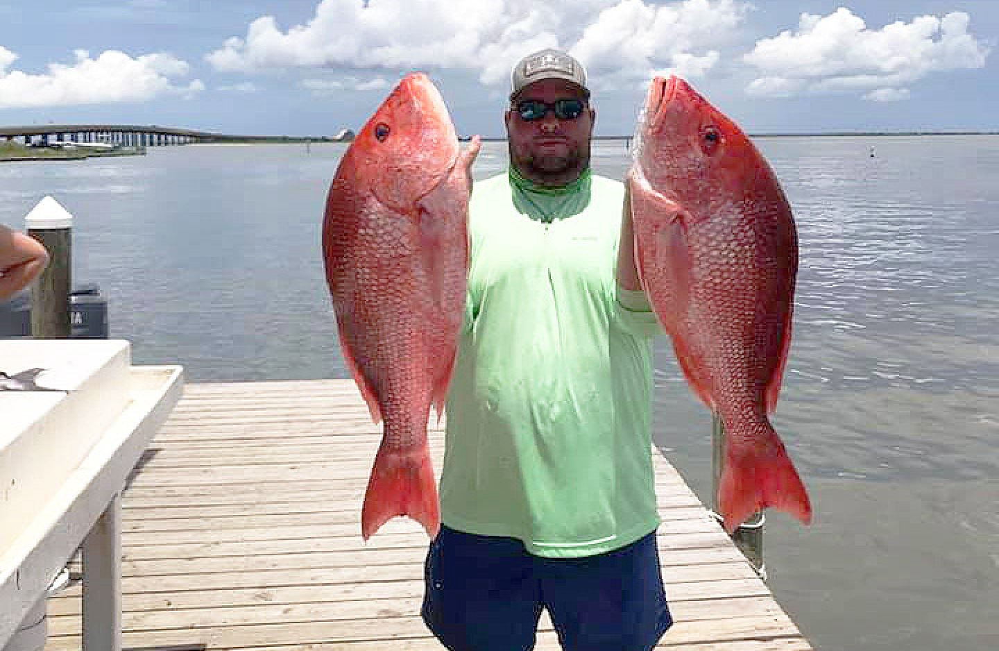 A person fishing on the shore of Dauphin Island