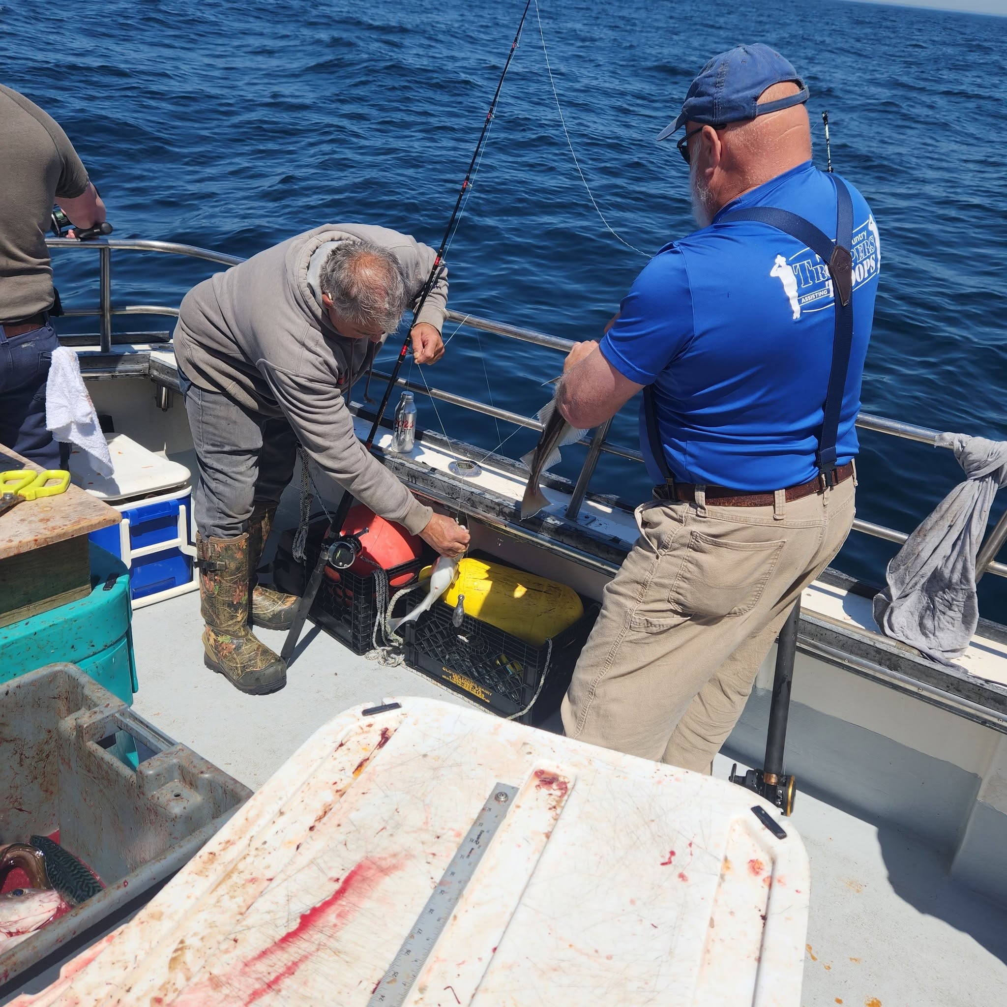 Fishing boat deck with equipment and tackle box during fishing trip in Rye NH
