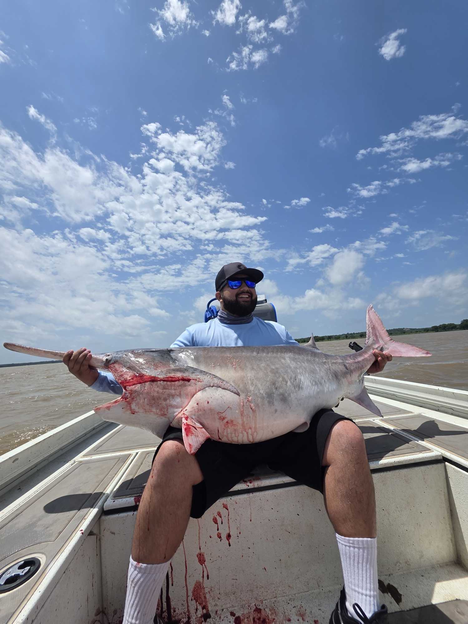 Large catfish caught during fishing tour in Glencoe OK displayed on boat deck