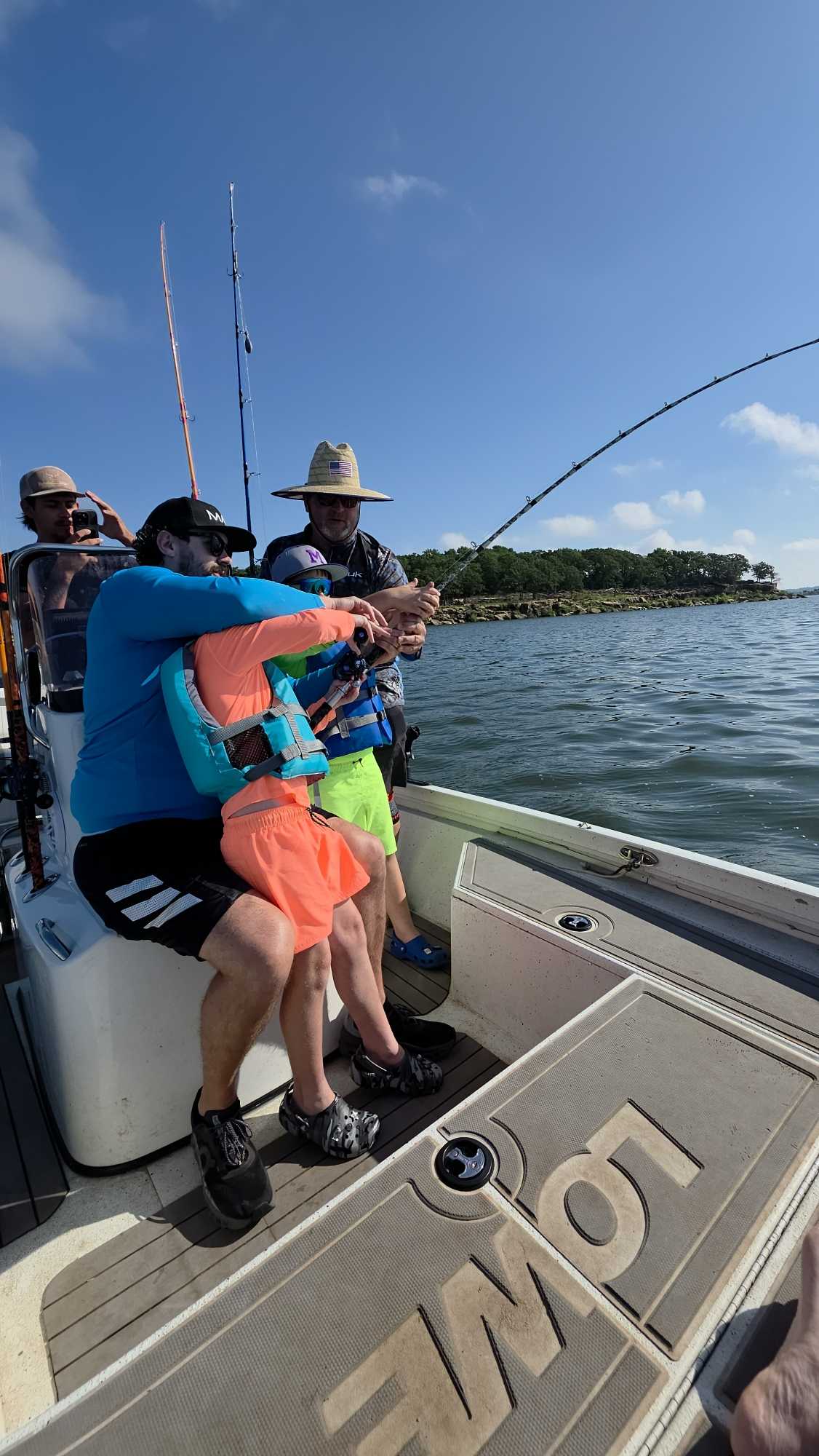 Fishing charter boat with multiple anglers holding fishing rods on open water near Glencoe OK