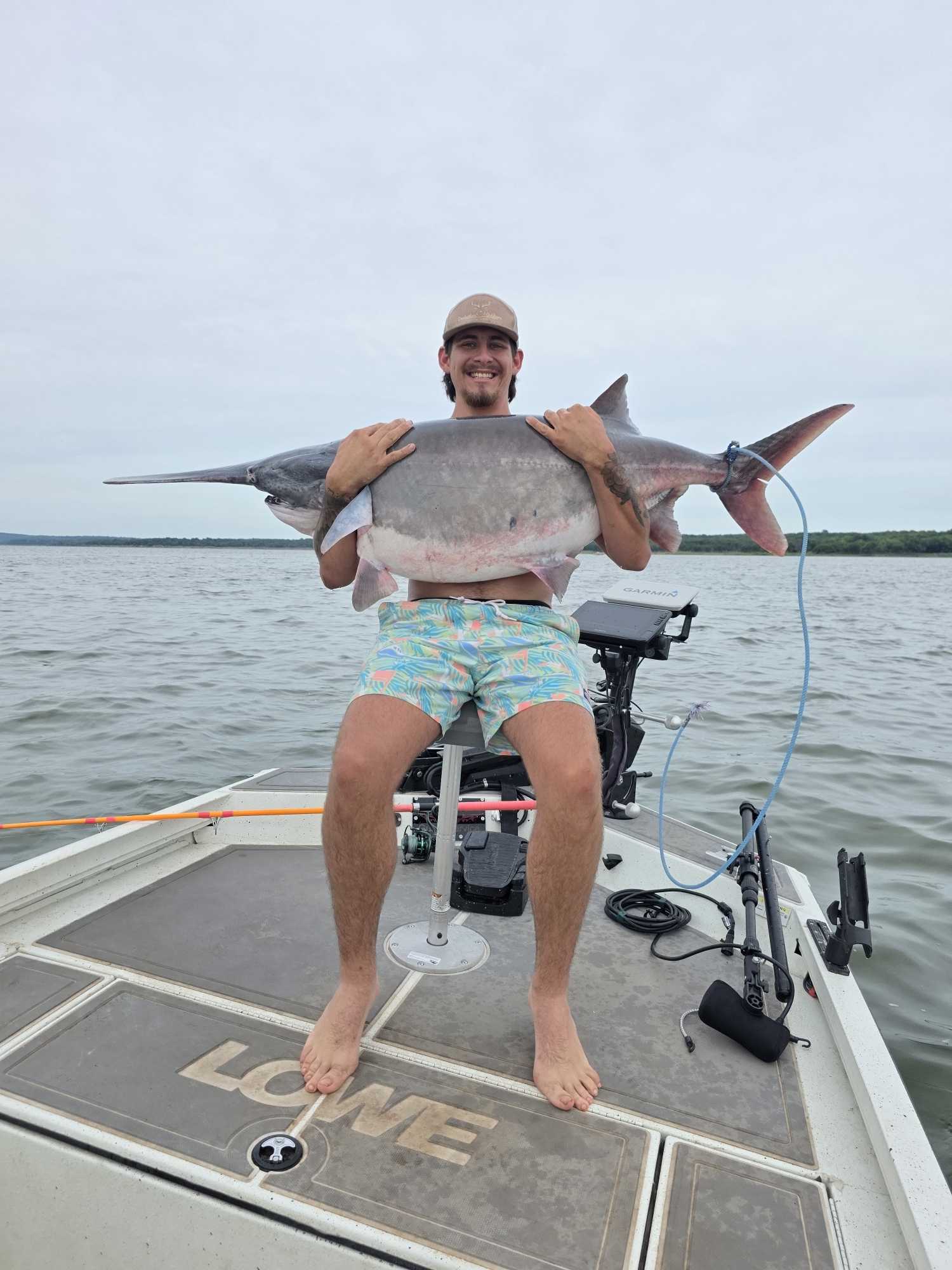 Large shark caught during fishing trip in Glencoe OK displayed on boat deck