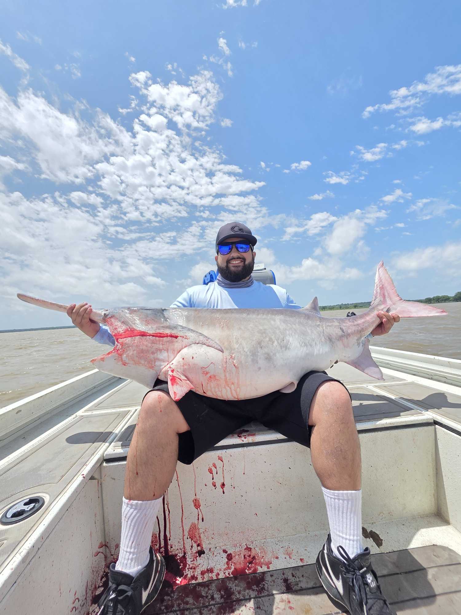 Large catfish caught during fishing tour in Glencoe OK displayed on boat deck