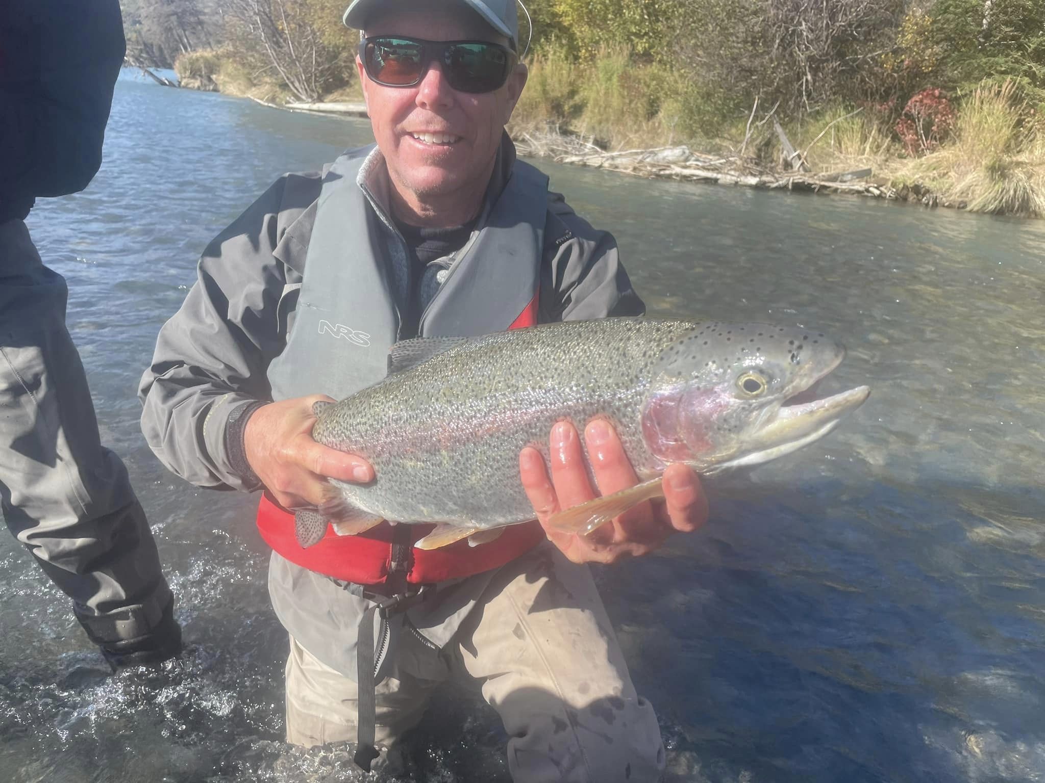 Angler holding a rainbow trout in Cooper Landing