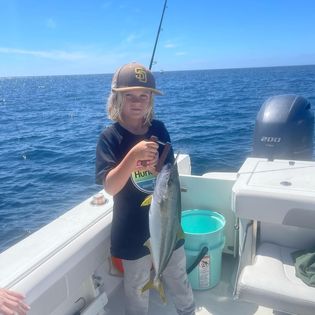 A fisherman holds a 19-inch catch in CA