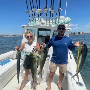 4 fishing rods and 2 people holding them in California