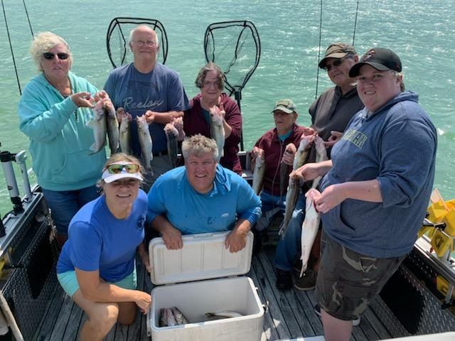 Two fishermen holding their catch in Wyandotte