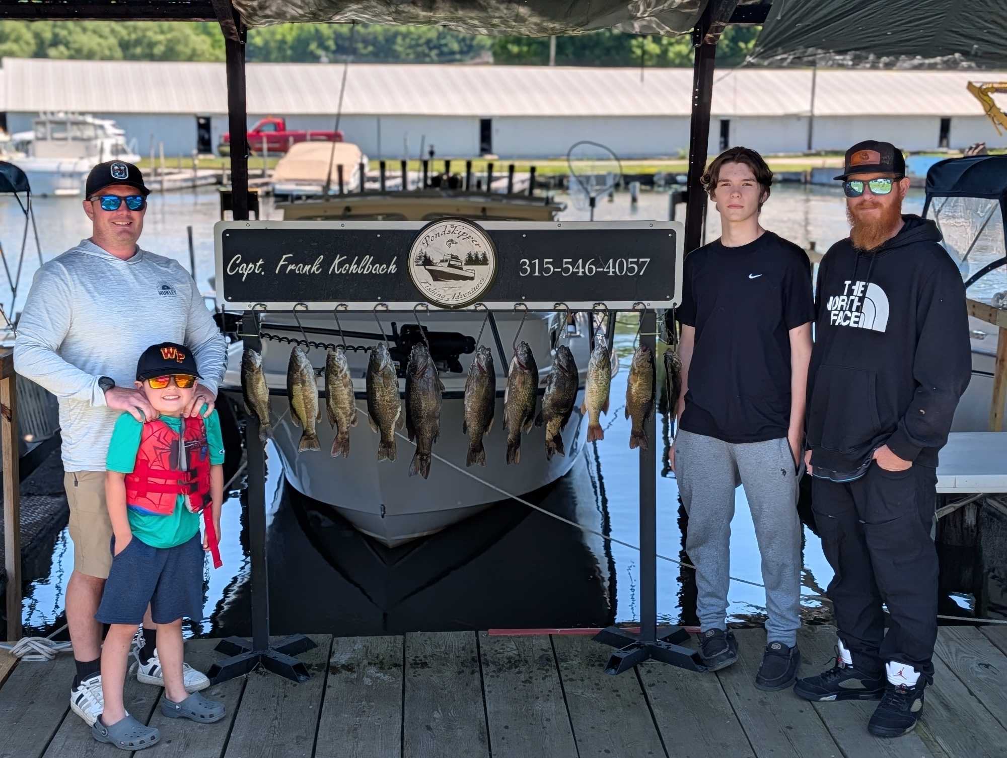 Successful smallmouth bass fishing trip in Henderson NY with multiple fish displayed on rack