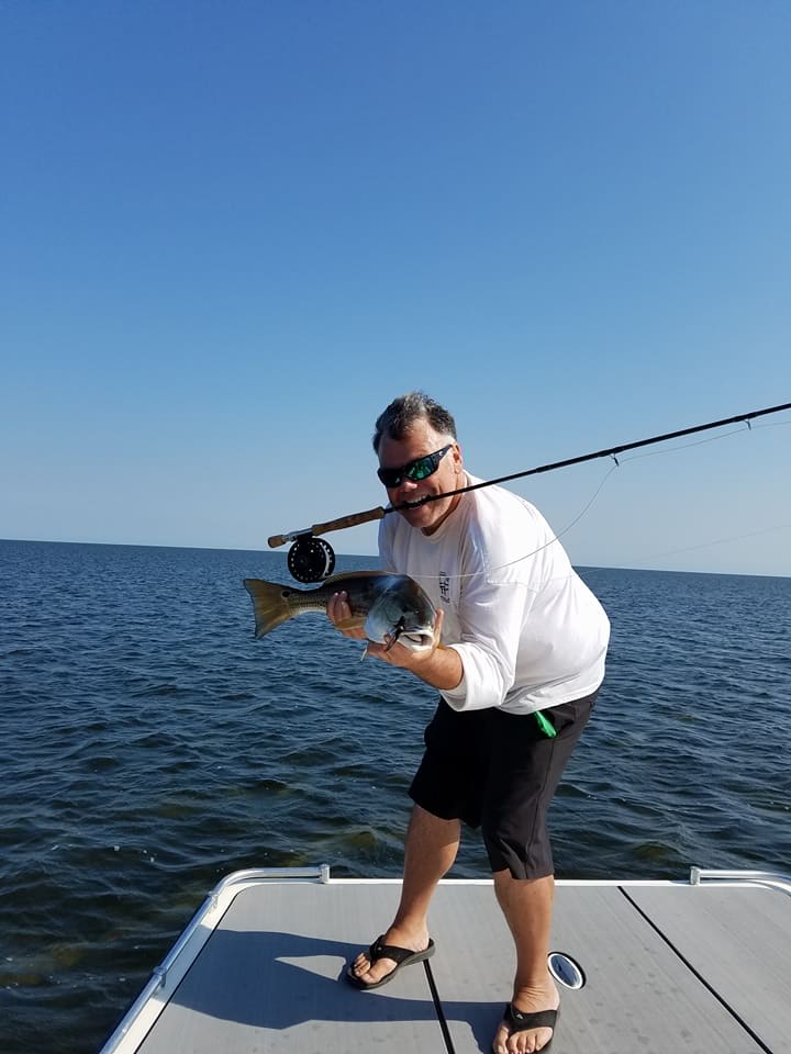 Fisherman catching a fish while fishing at Hatteras