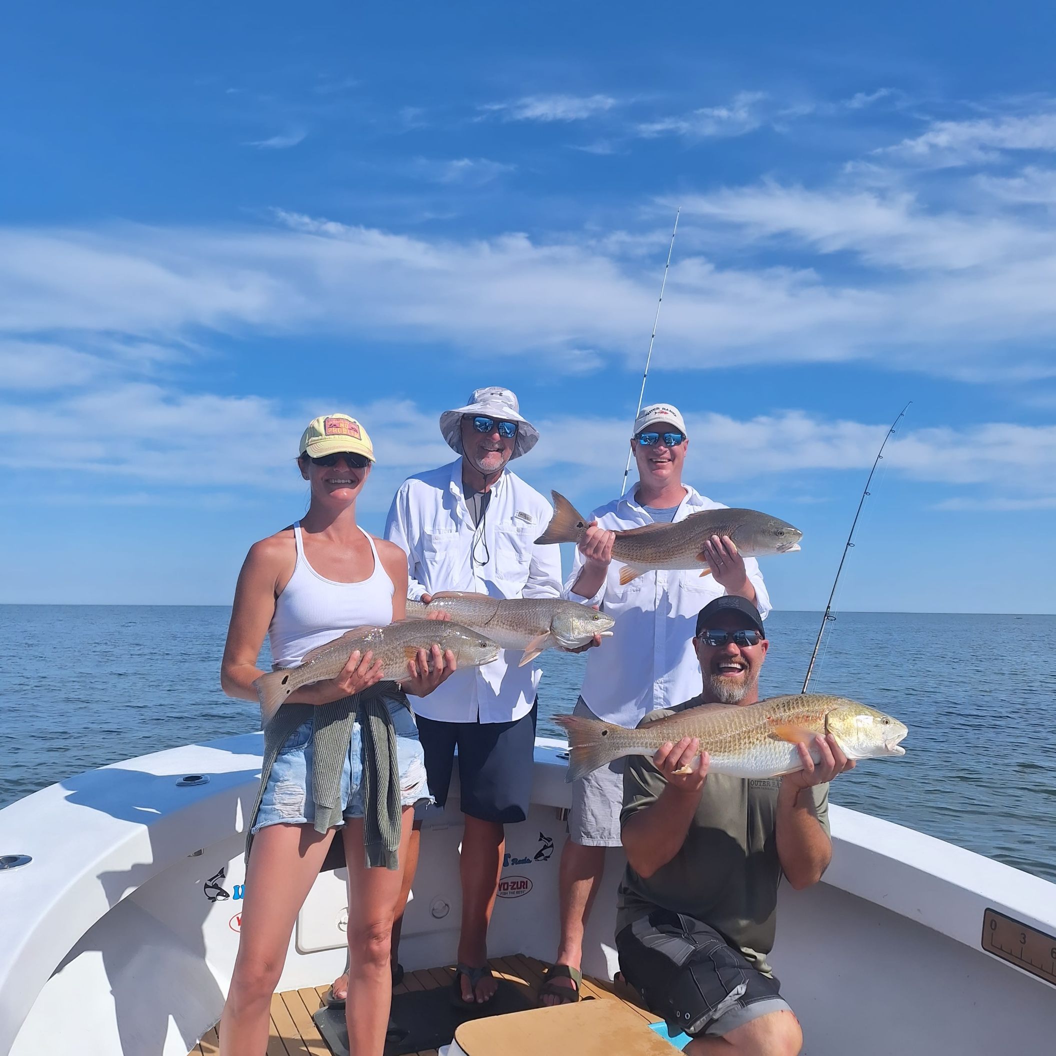 Red drum fishing charter boat in Hatteras NC shallow waters with Captain Aaron guiding anglers