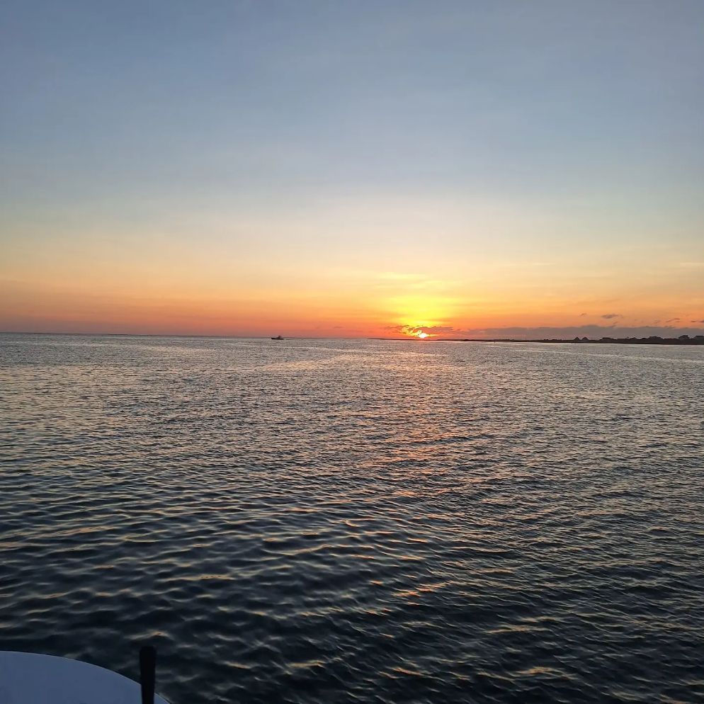 Hatteras NC sunset fishing charter boat on Pamlico Sound flats targeting red drum