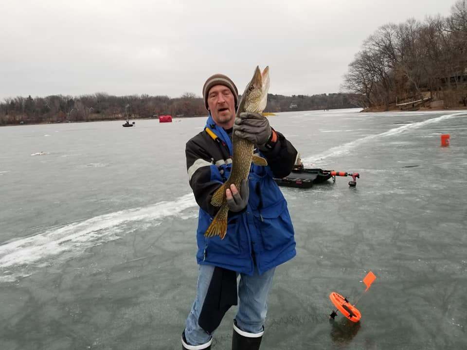 Fisherman holding 15-inch fish in Minnesota