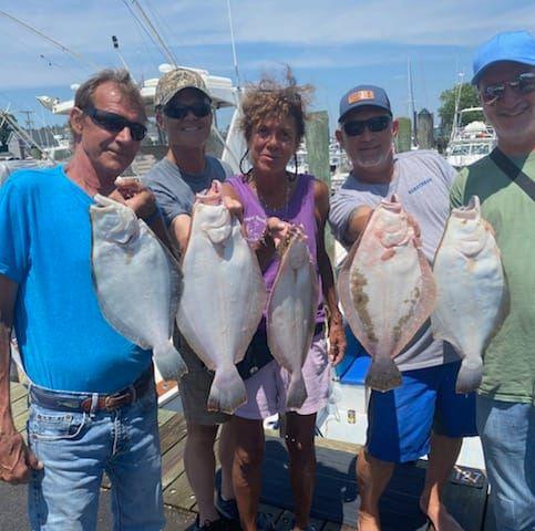 Five large fish displayed at Leonardo State Marina NJ after successful fishing trip