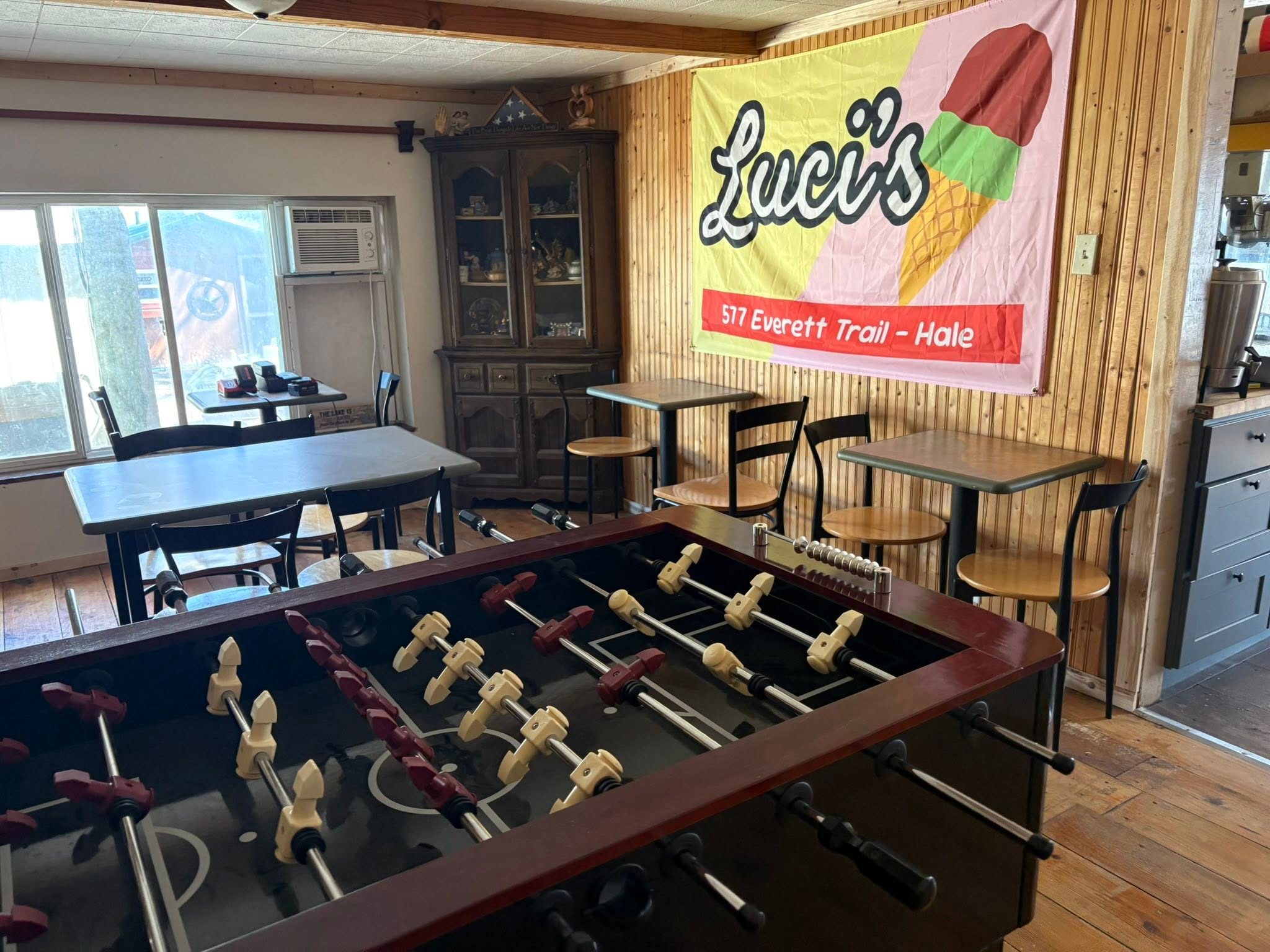 Interior of Lucy's ice cream shop and tour office in Hale MI with foosball table and dining area