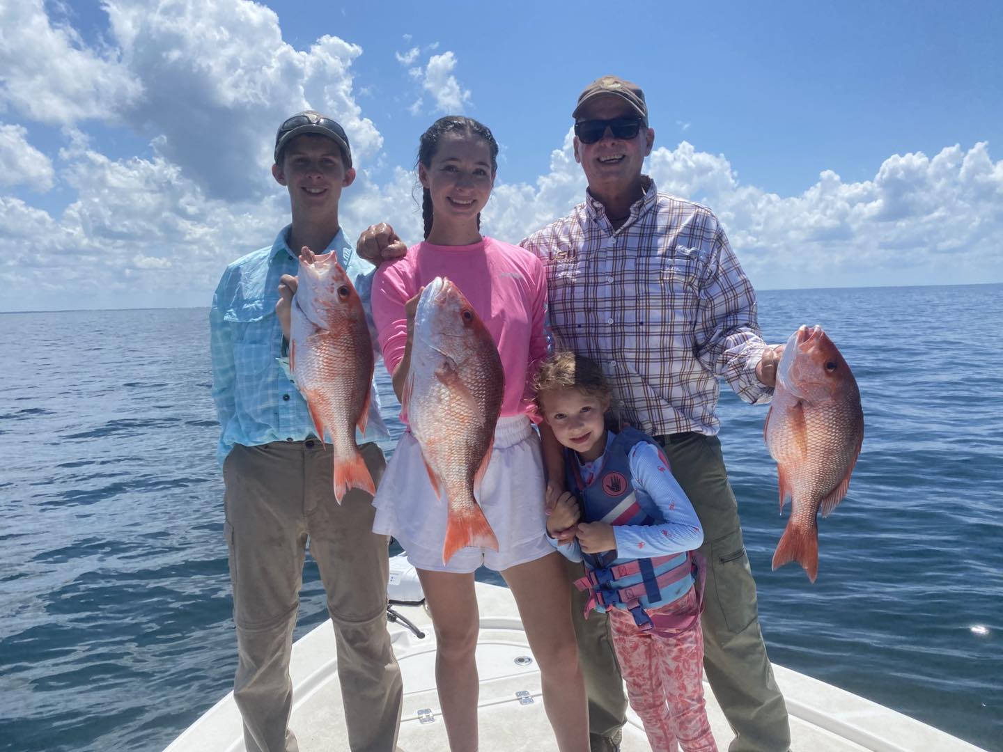Group of 4 people fishing for 3 big fish in Port St. Joe