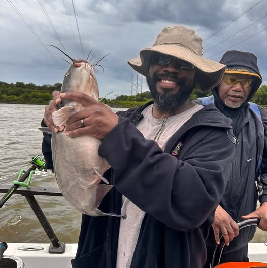 Fresh caught catfish being held up on fishing boat in Wagoner OK