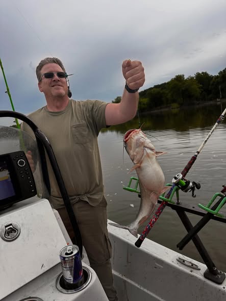 Angler displaying freshly caught fish on boat in Wagoner OK waters