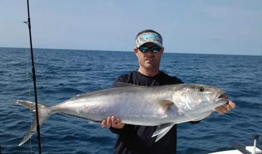 A single fisherman holding a 37-inch catch in Beaufort