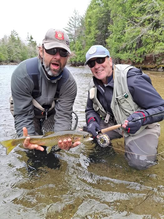 Two anglers holding Atlantic salmon in river in Poland, Maine