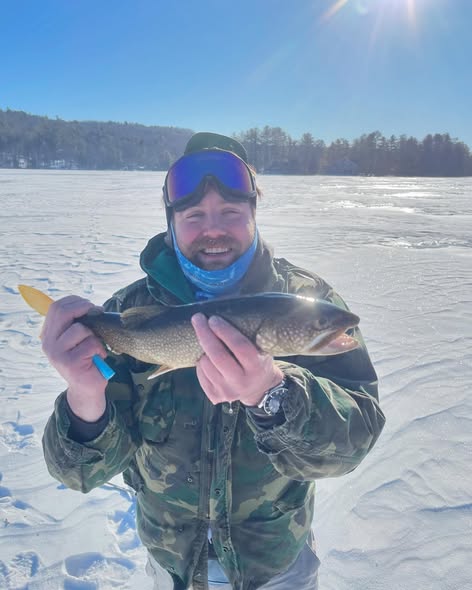 Lake trout caught while ice fishing in Poland, Maine on frozen lake