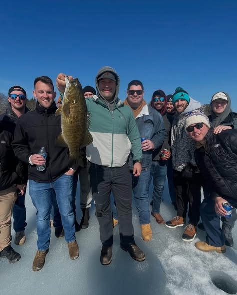 Group of anglers on ice fishing trip in Poland ME displaying caught smallmouth bass