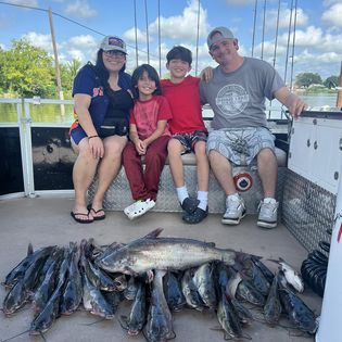 4 people fishing on the water in TX