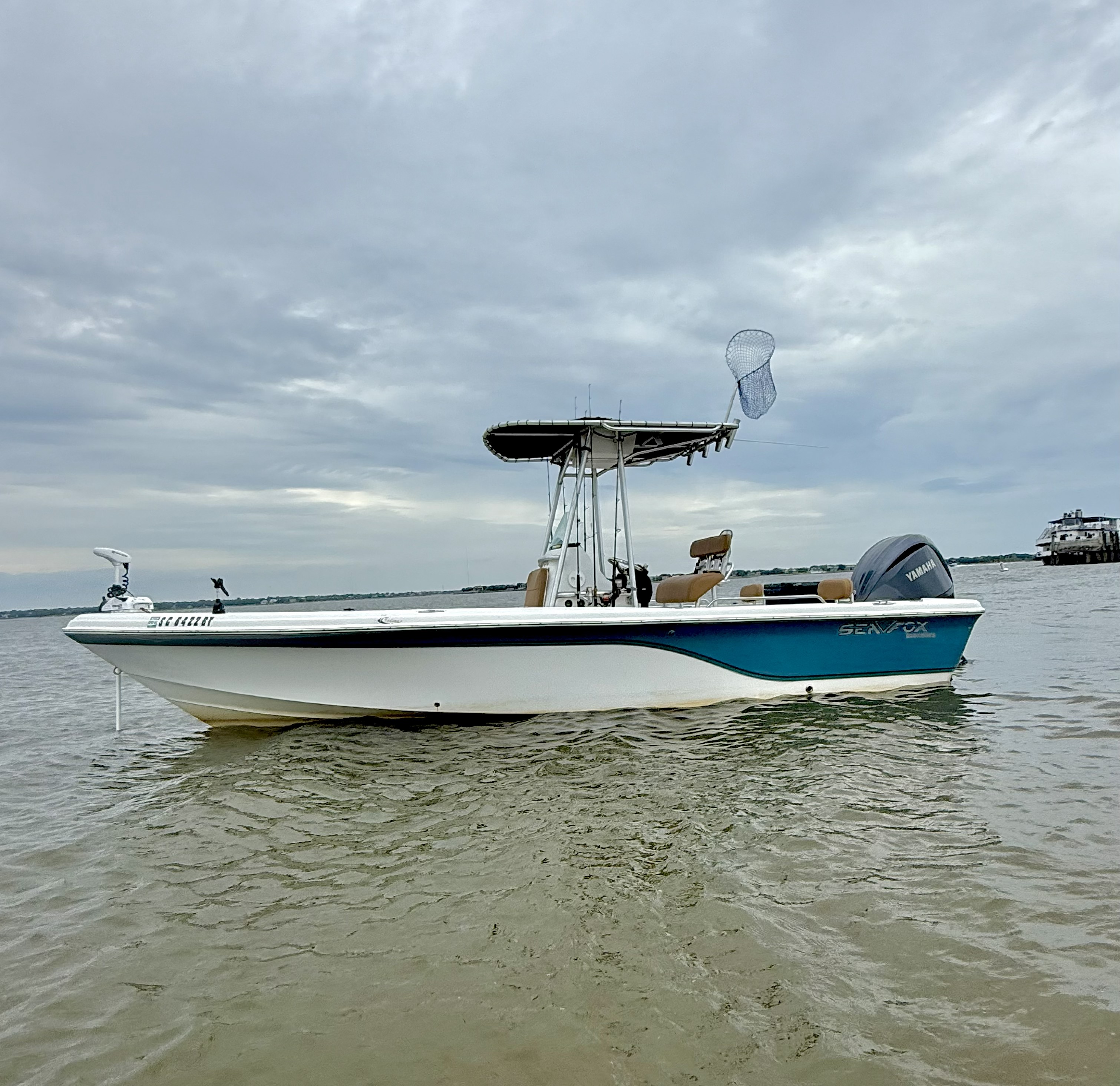 Sea Fox fishing boat anchored in shallow water near Charleston SC with T-top and outboard motor