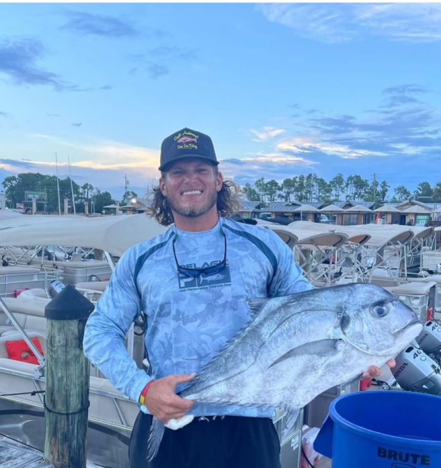 Angler with a huge African Pompano fish in FL