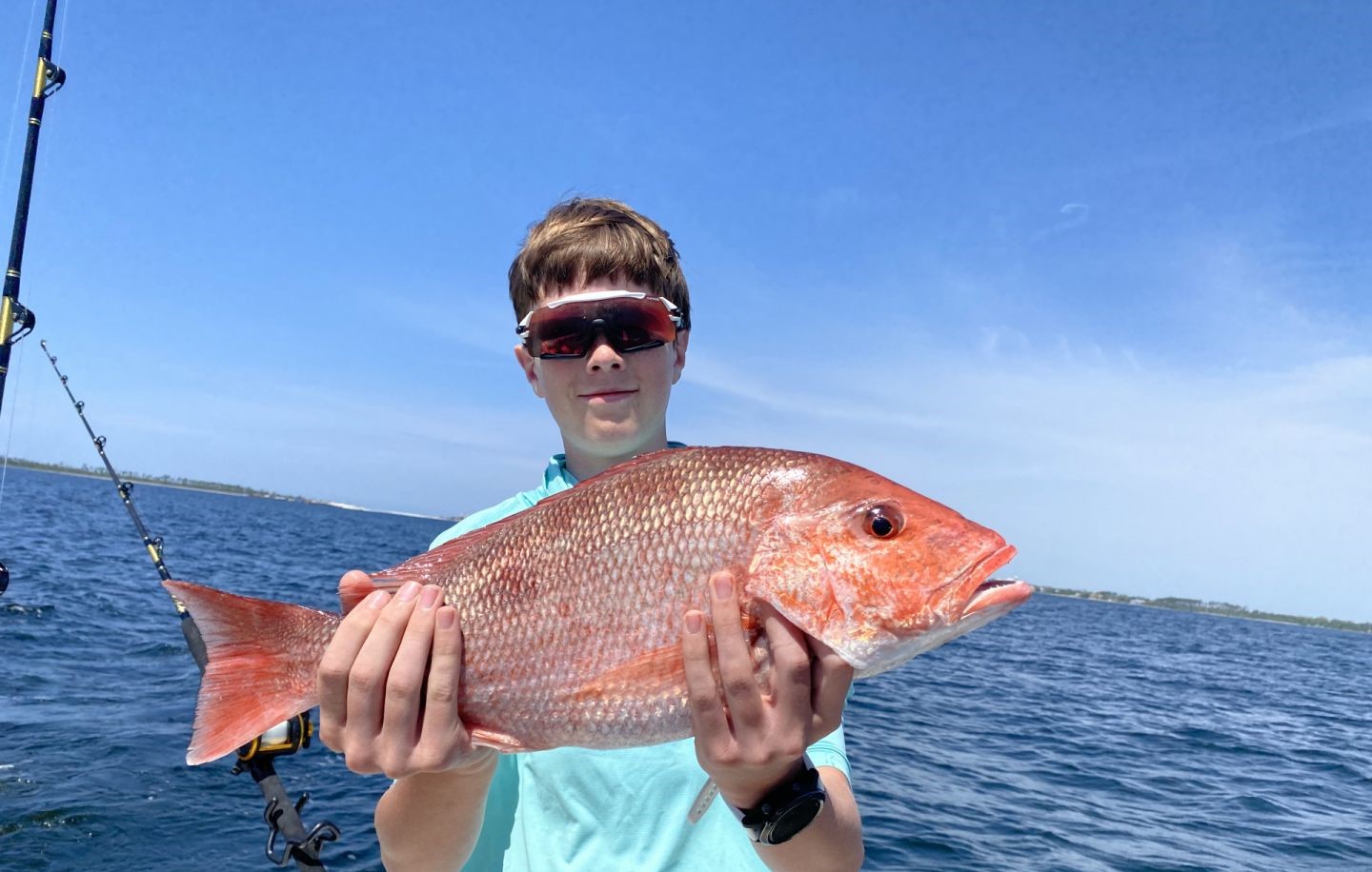 Angler holding a fishing rod on the beach in Panama City Beach