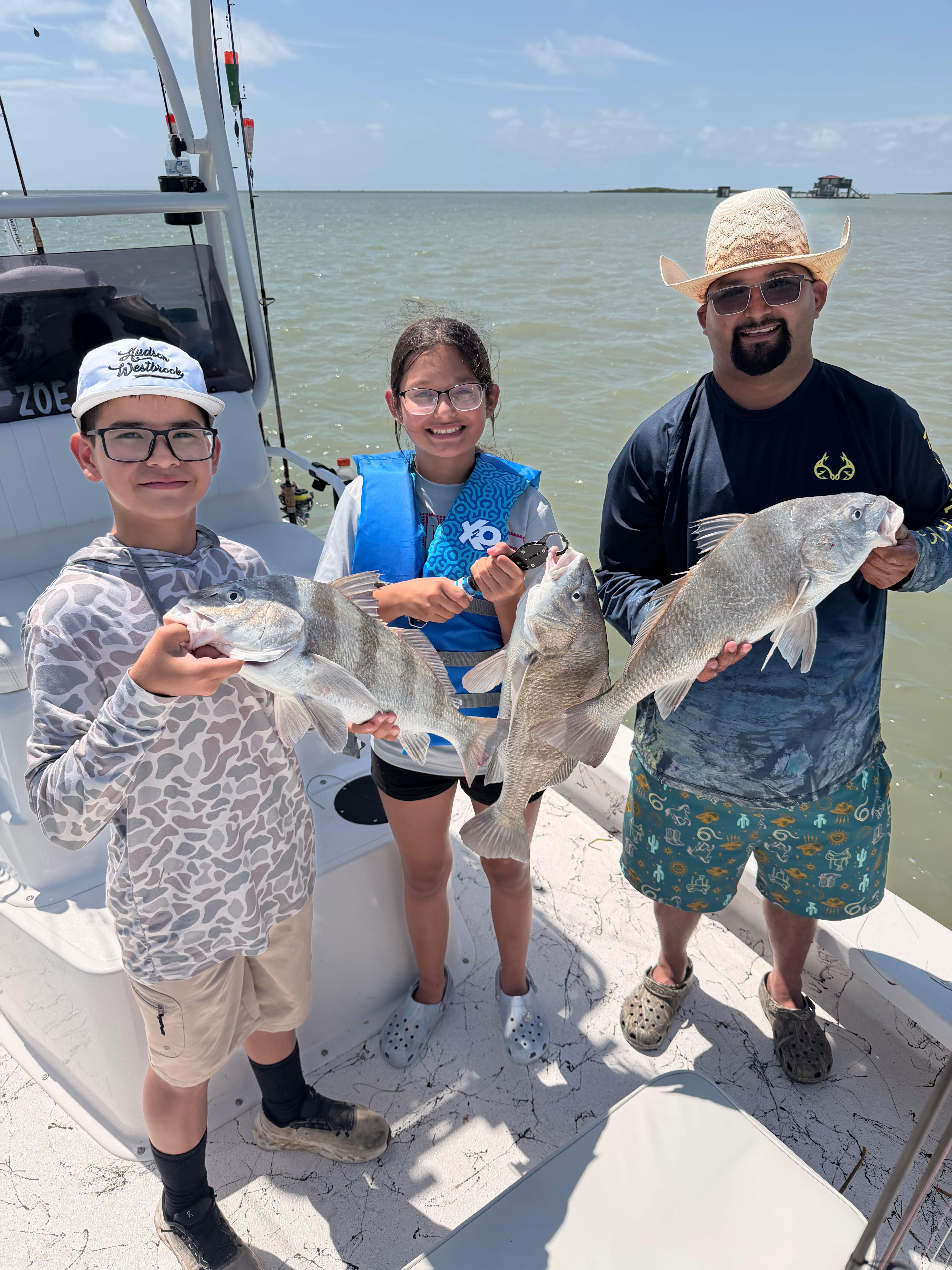 Successful fishing trip showing three black drum caught near South Padre Island TX on charter boat