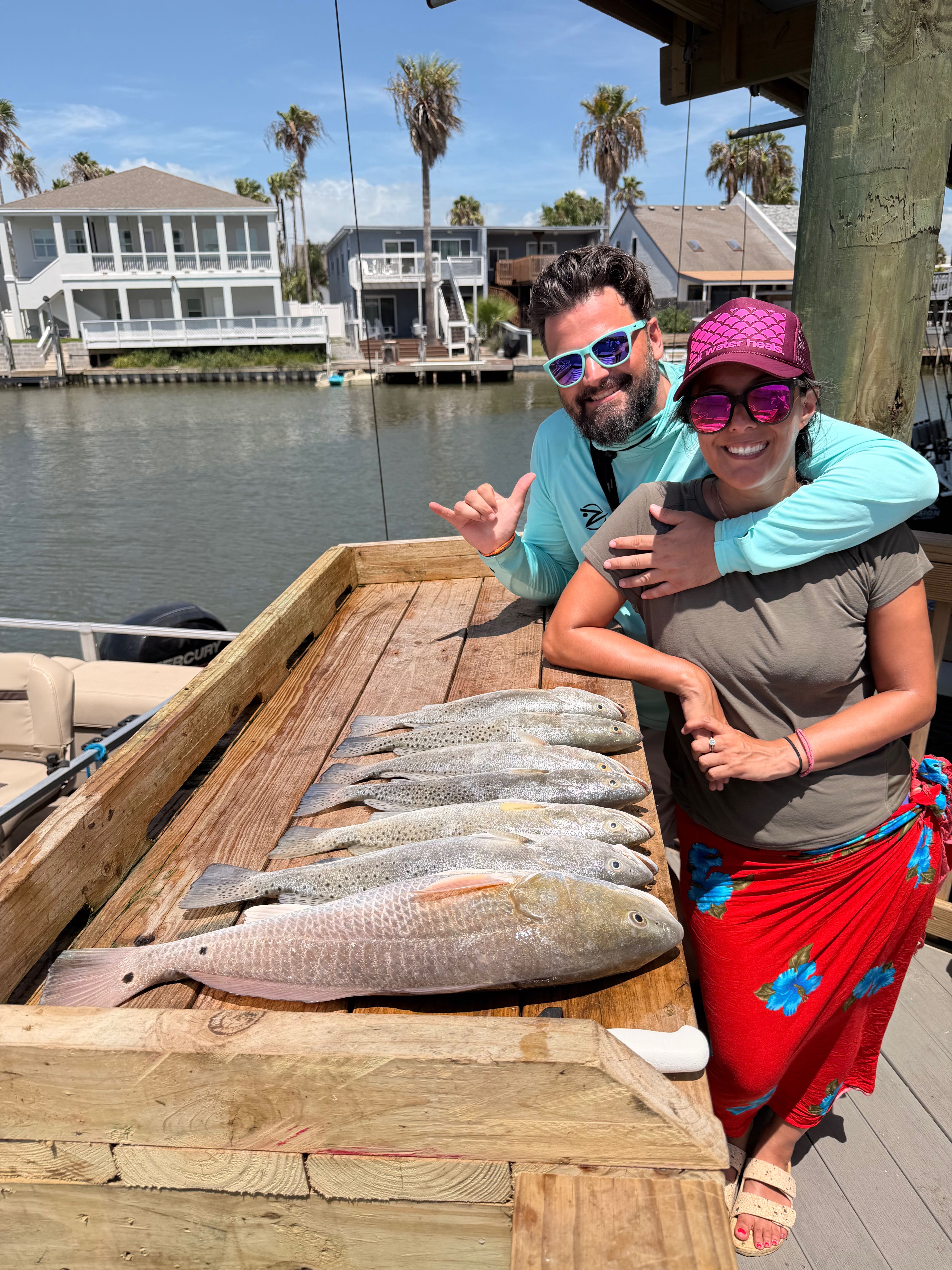 Fresh caught redfish displayed on wooden dock at South Padre Island TX fishing charter