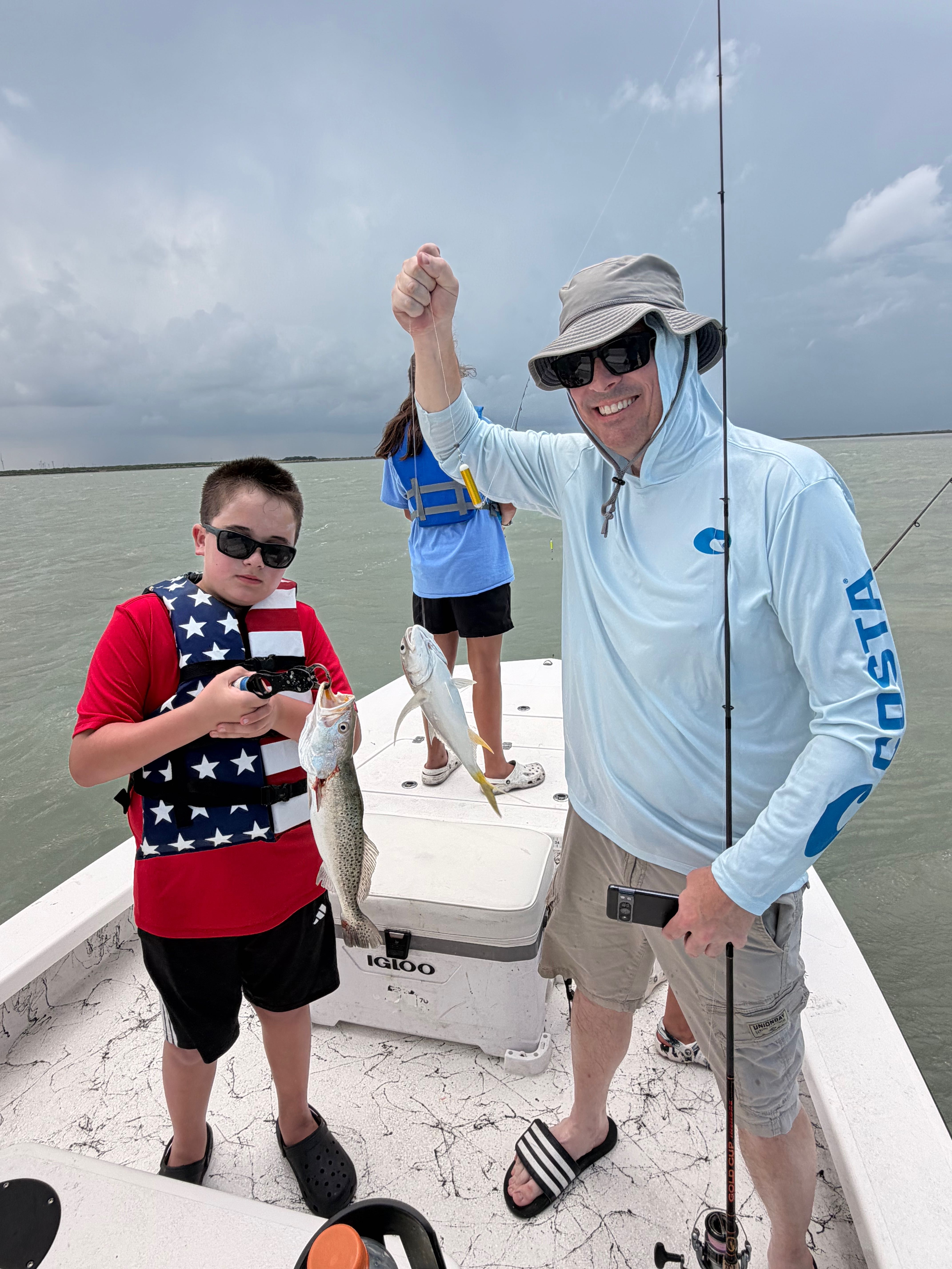 Successful fishing trip on South Padre Island TX showing caught speckled trout and crevalle jack on boat deck