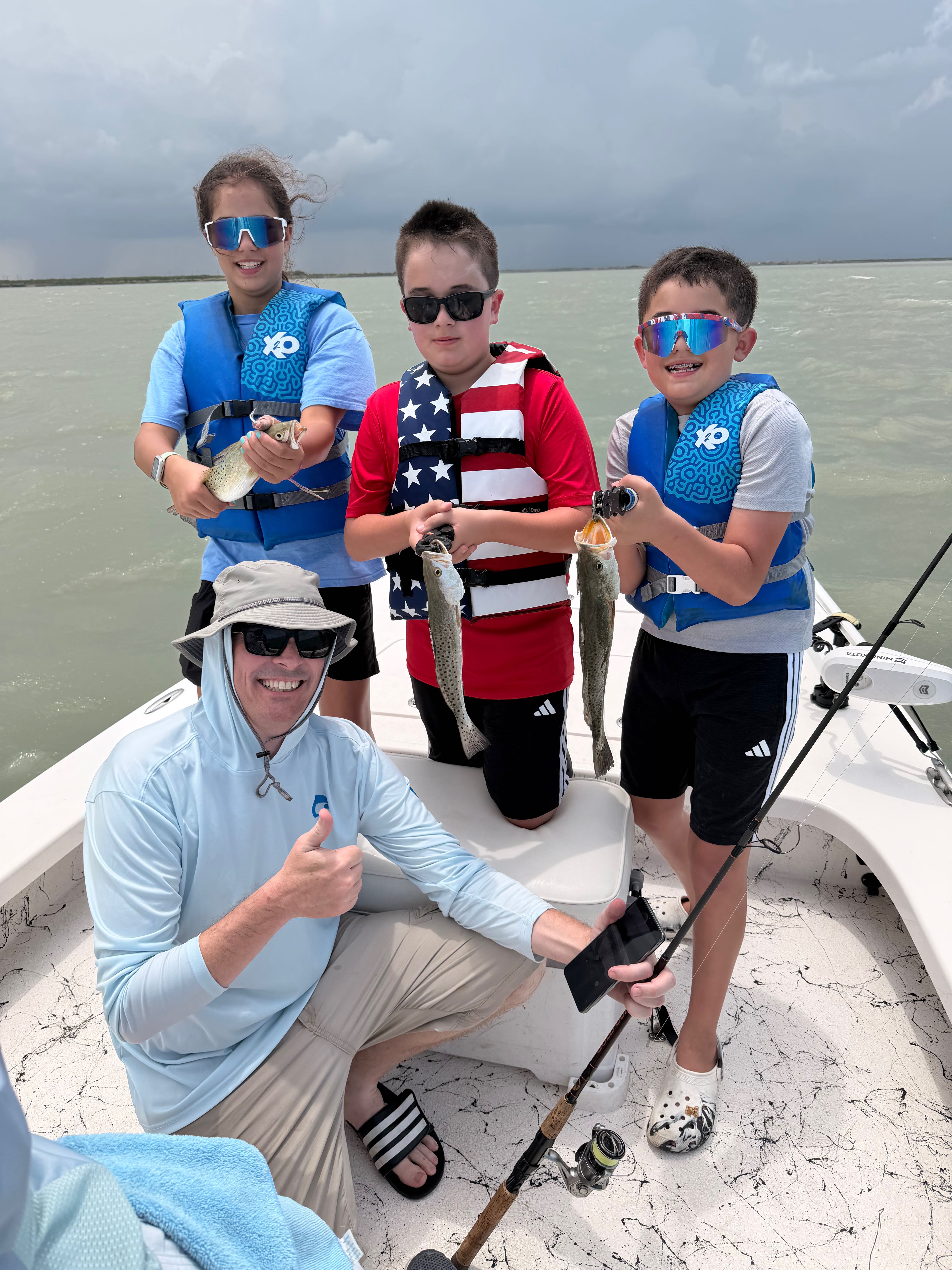 Successful fishing trip displaying caught speckled trout on boat in South Padre Island TX waters