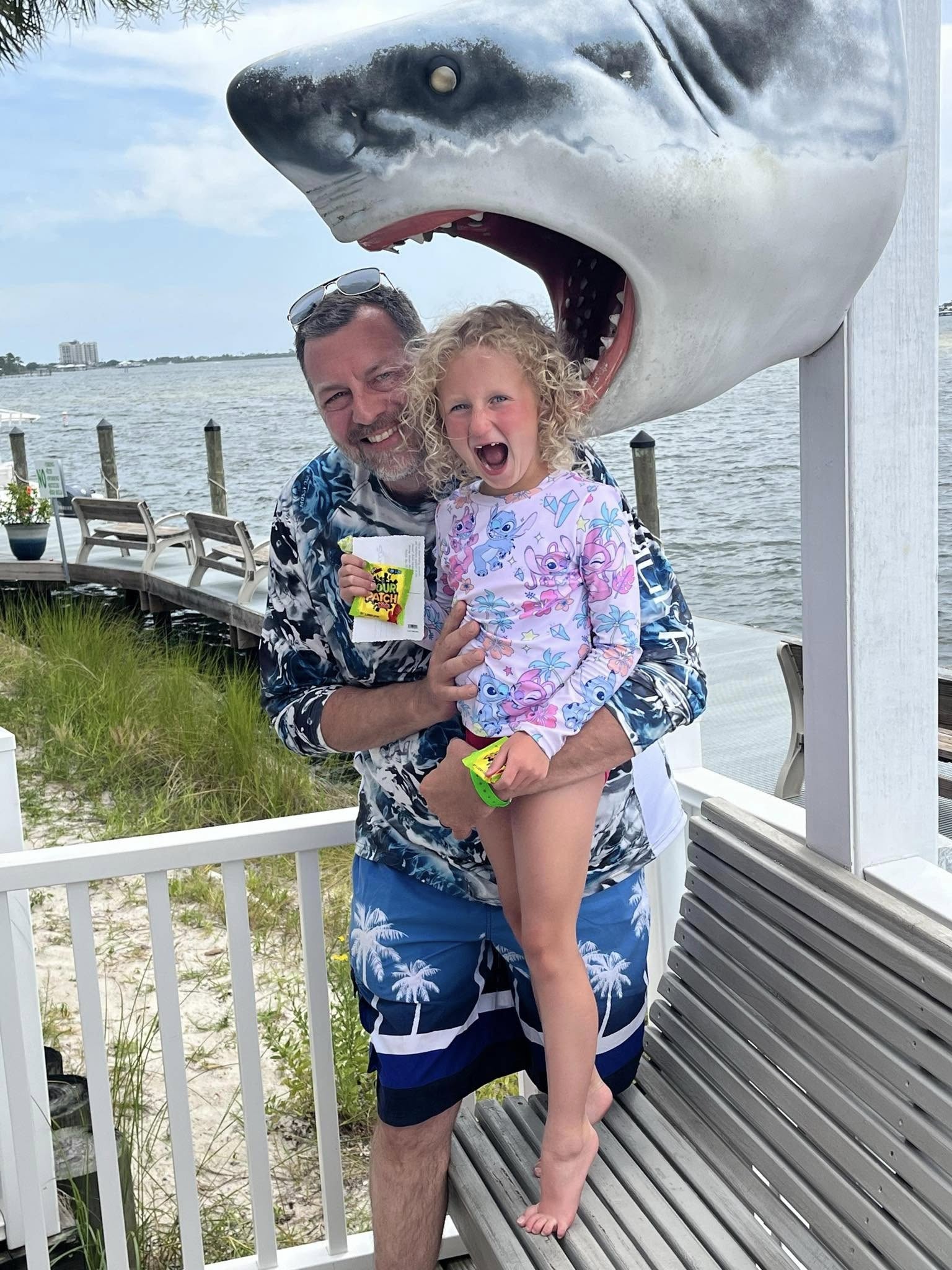 Great White Shark display with tourists posing underneath at Orange Beach AL waterfront location
