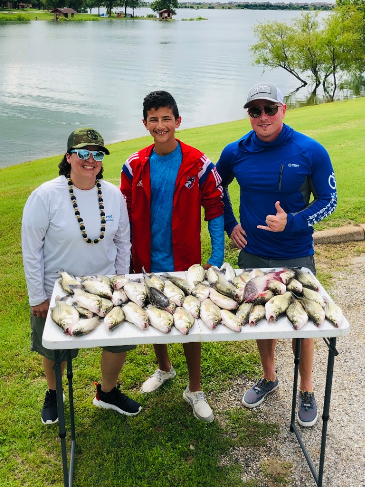 Three people enjoying a fishing trip in TX