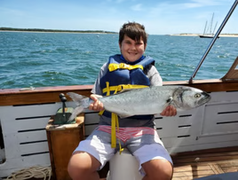 Angler holding a 24-inch fish in Falmouth