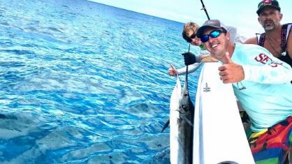 Two anglers holding a large 22-inch fish in Florida