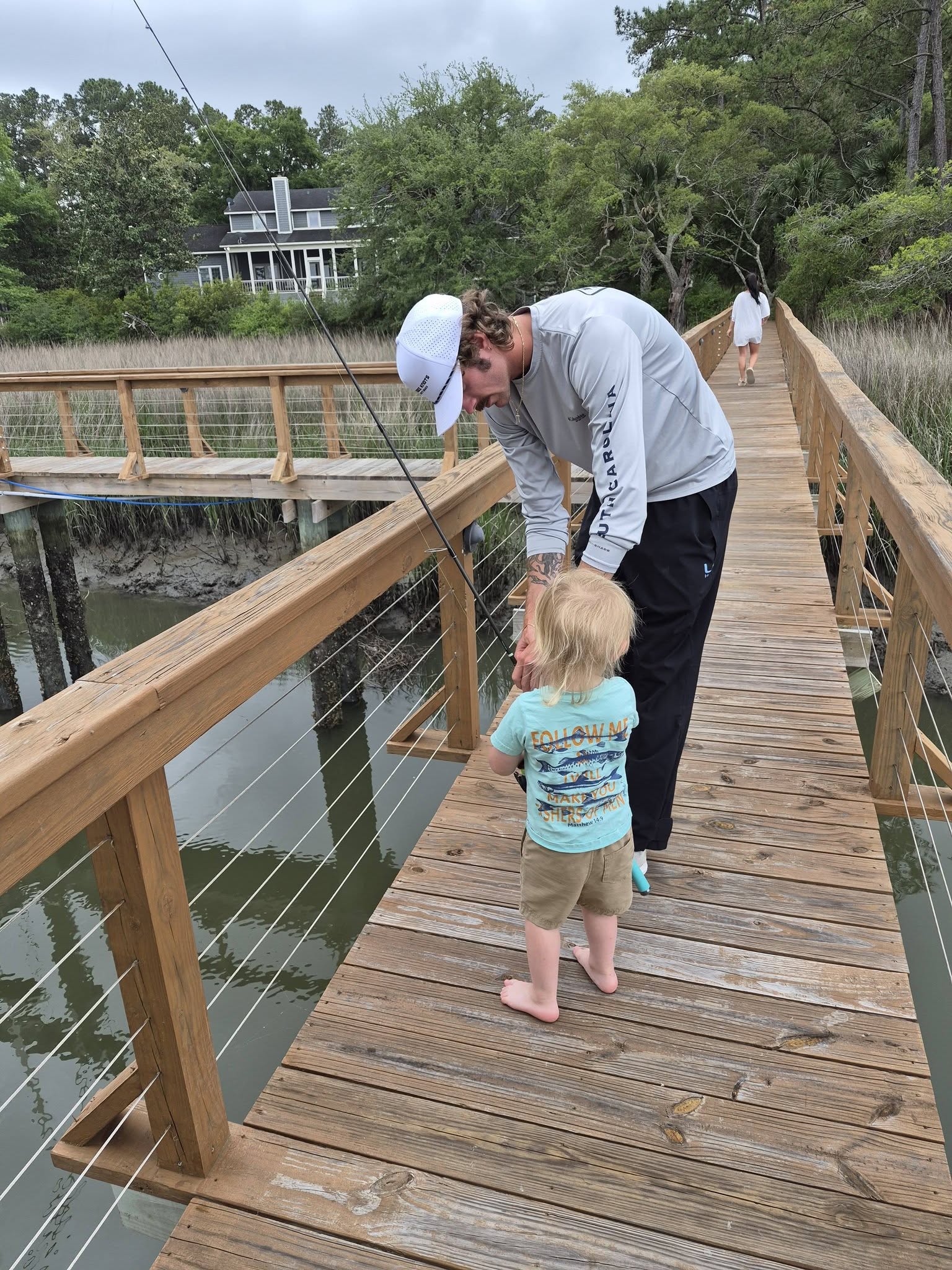 Fishing from wooden dock over water in Edisto Beach SC