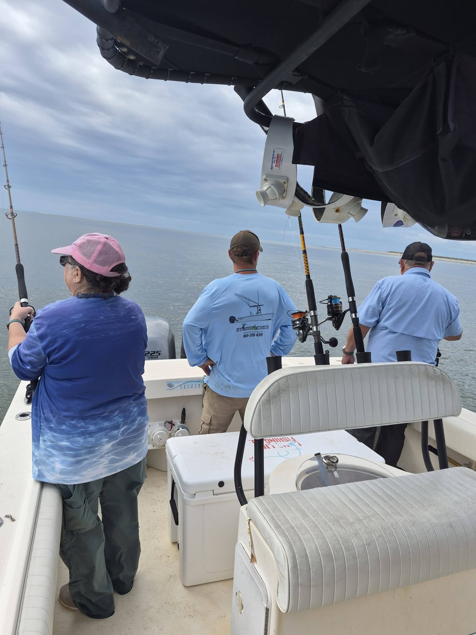 Fishing charter boat on water near Edisto Beach SC with multiple fishing rods and equipment