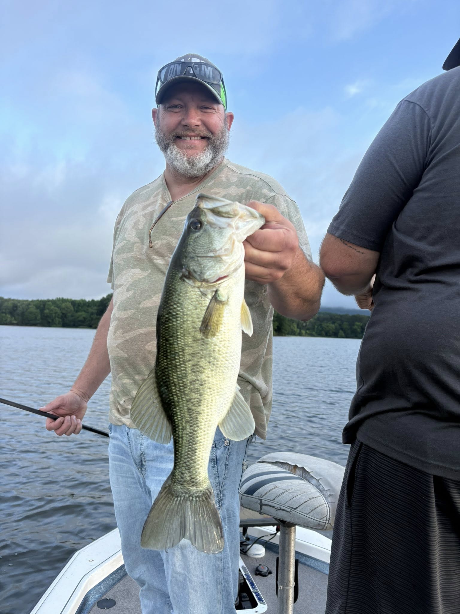 Angler holding large bass fish on boat in Chattanooga TN lake