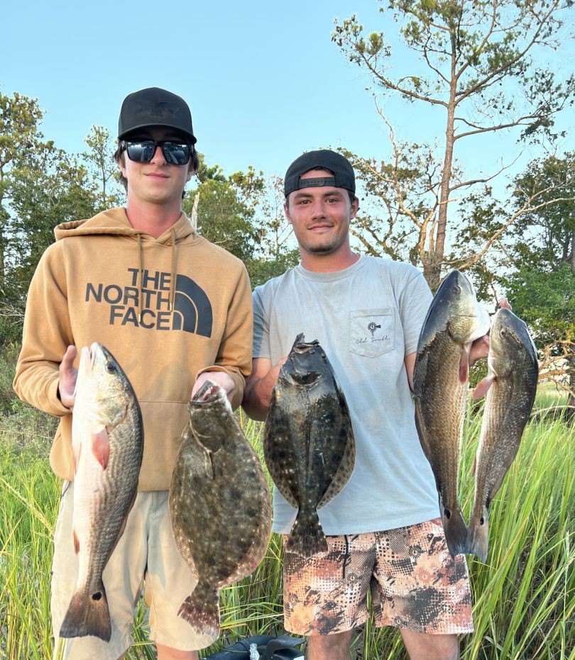 Two anglers fishing with redfish and southern flounder at Isle of Palms Beach