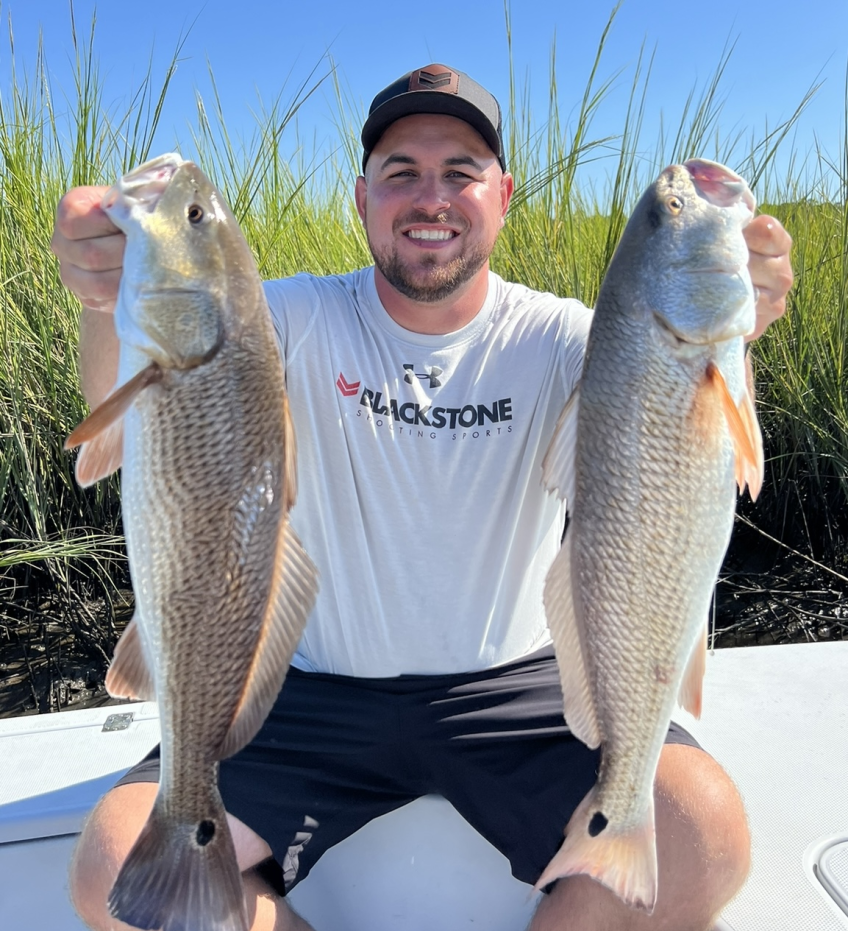 Two redfish caught on fishing trip at Isle of Palms Beach