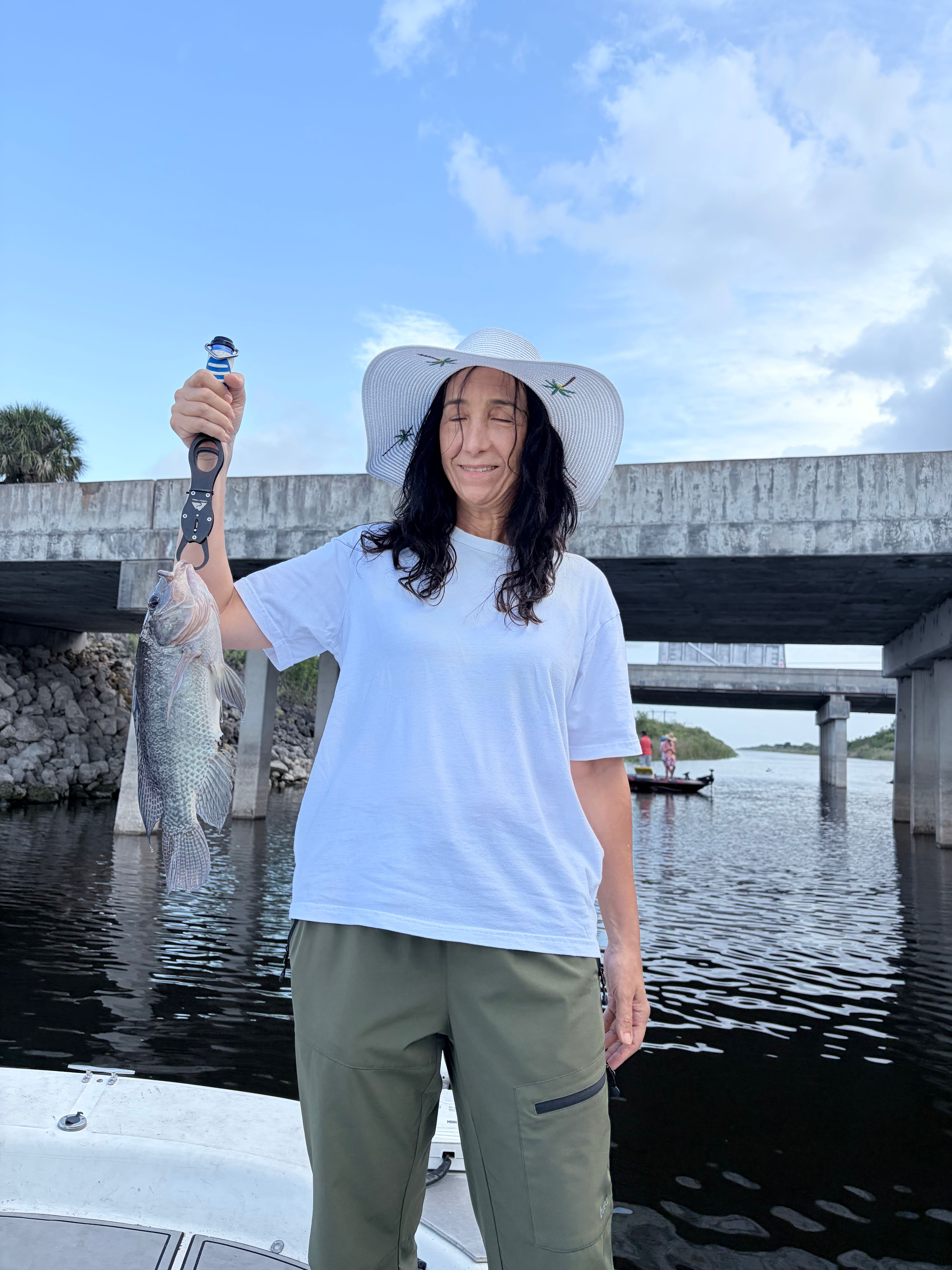 Fresh caught fish being held up after successful fishing trip in Weston FL