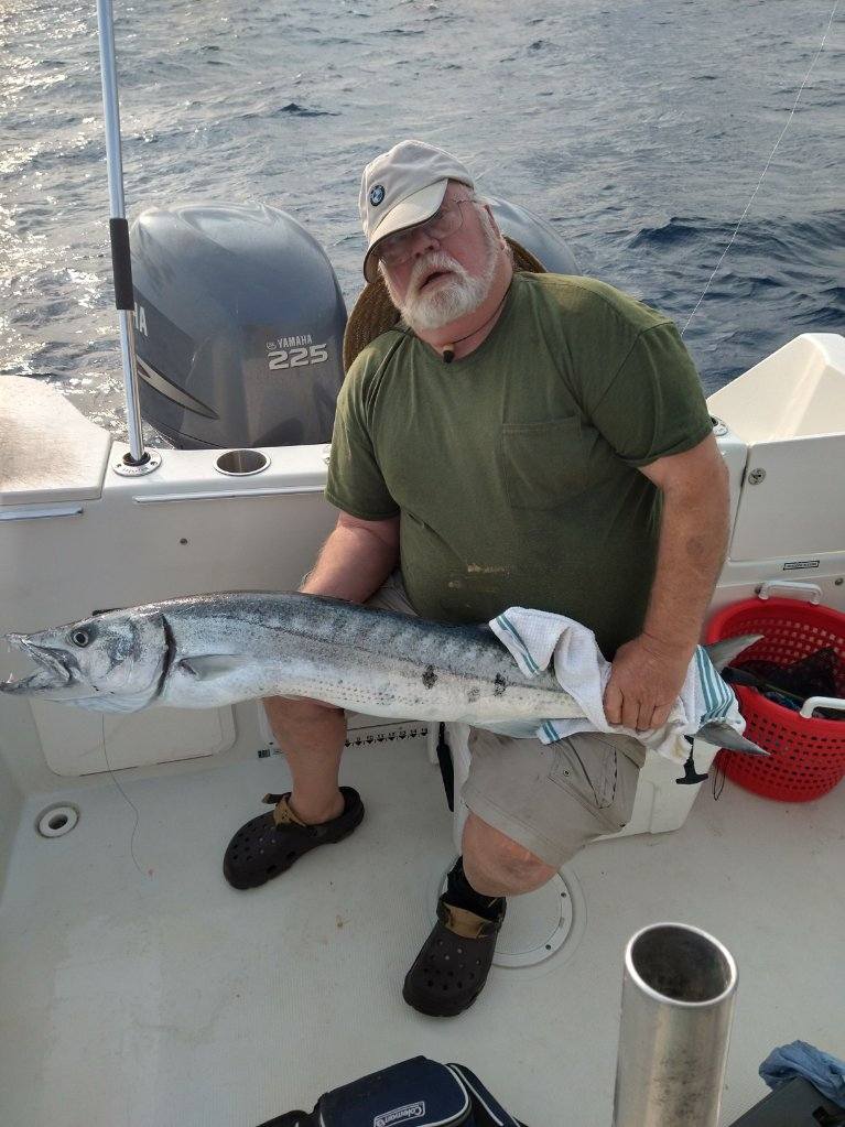 A lone angler in Morehead City, fishing for the best catch.