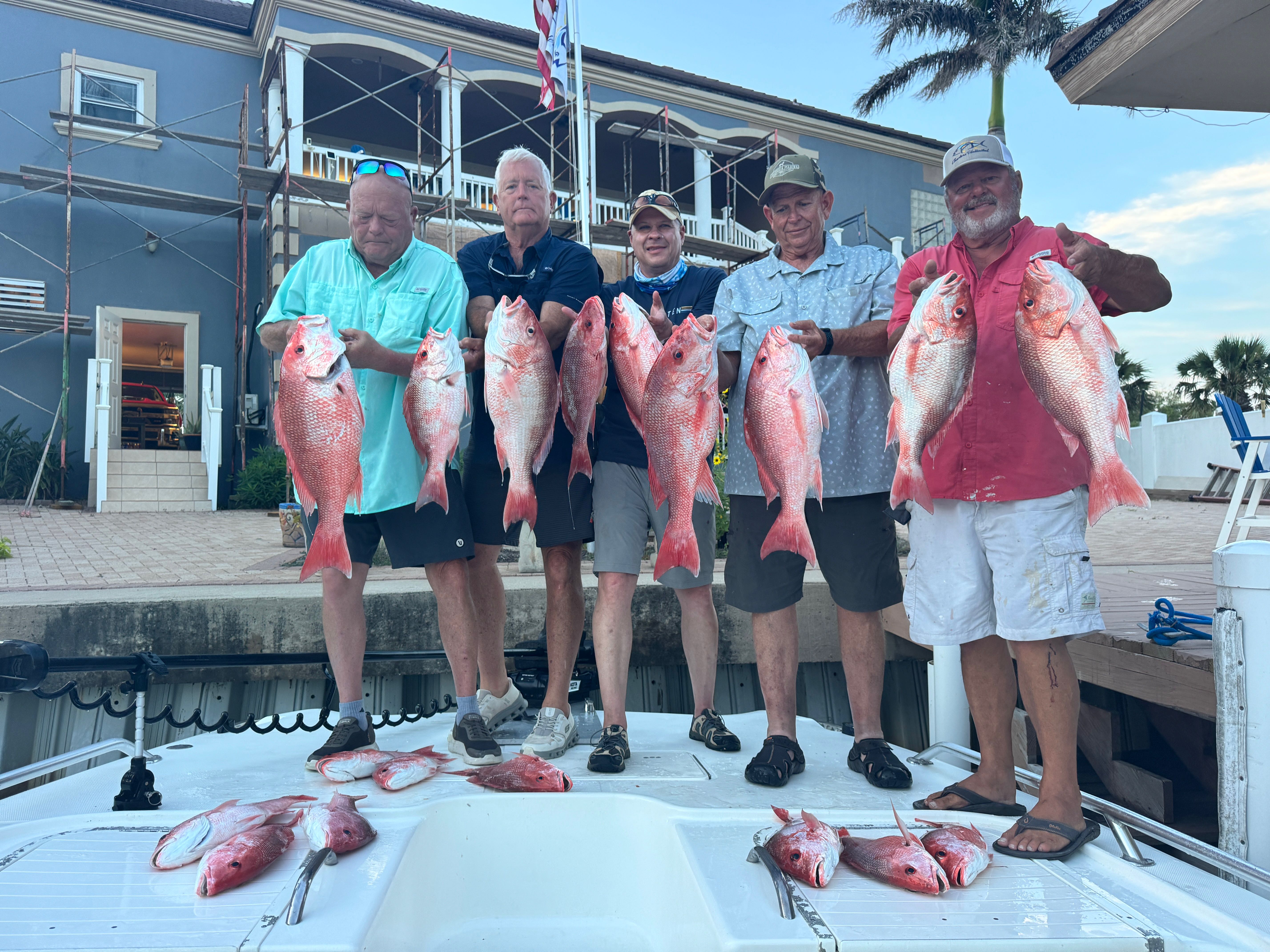 Red snapper fishing catch displayed at Port Isabel TX marina with multiple fish laid out