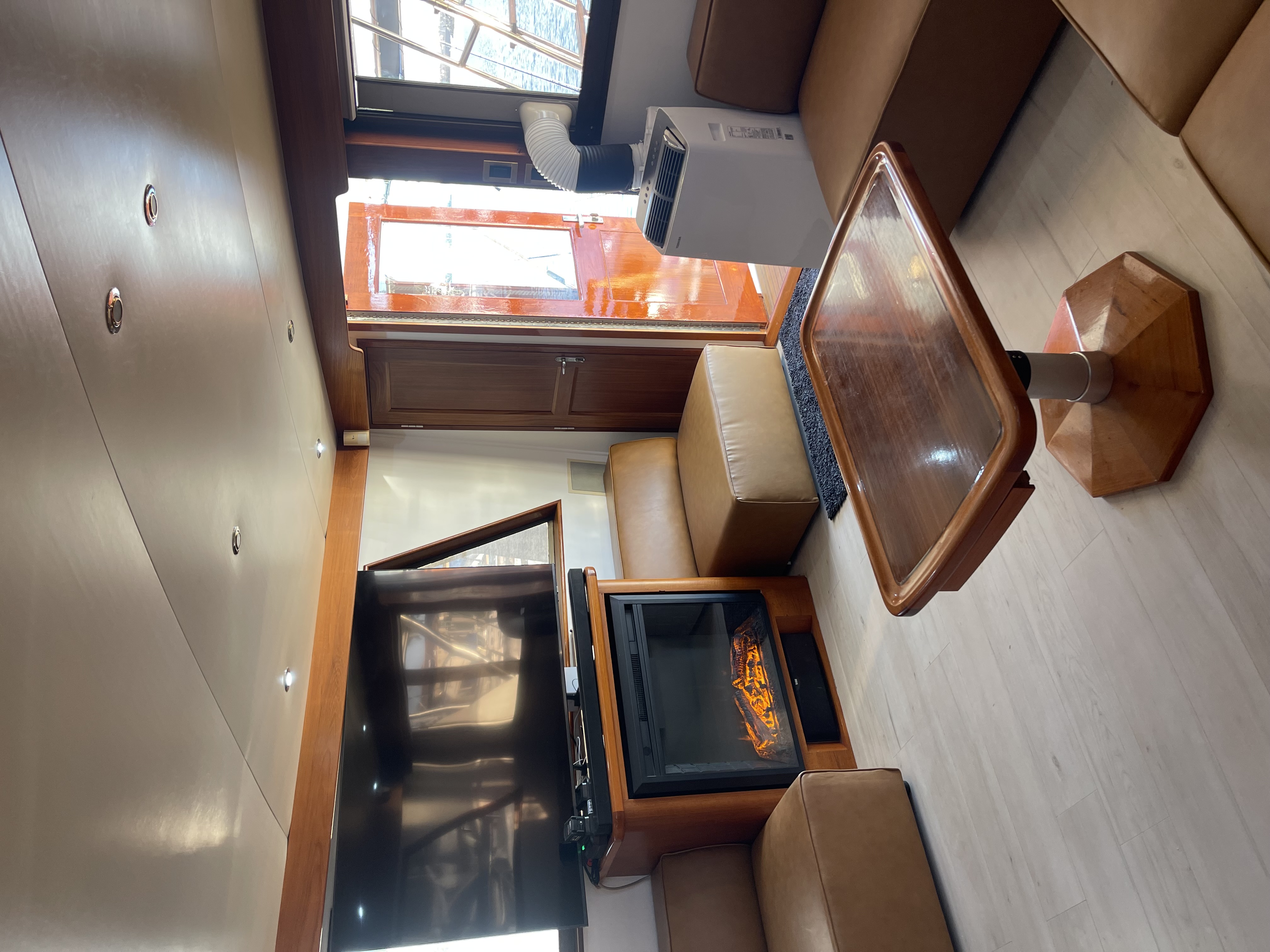 Interior cabin of fishing charter boat in San Diego CA showing seating area and entertainment system