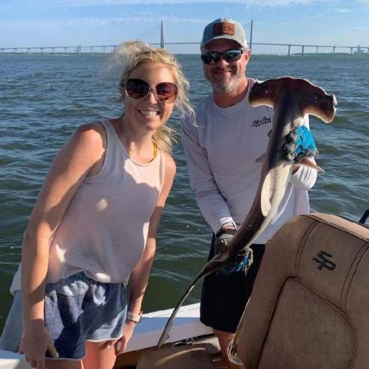 A couple holding a 23-inch fishing rod in SC